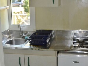 Fridge, microwave, coffee/tea maker, cookware/dishes/utensils