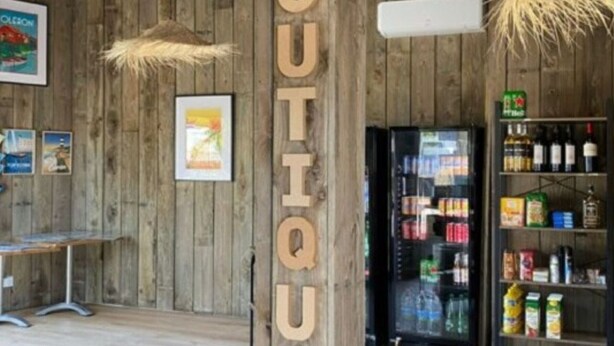 A wooden interior with a 'BOUTIQUE' sign, a refrigerator stocked with beverages, and a shelf with snacks. - Mobile Home with Terrace for 4 ppl, 2 BR (Dolus-d'Oléron)