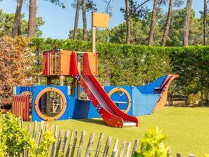 A playground with a slide and climbing structures. - Cozy Mobile Home - 2 Br, Terrace (Messanges)