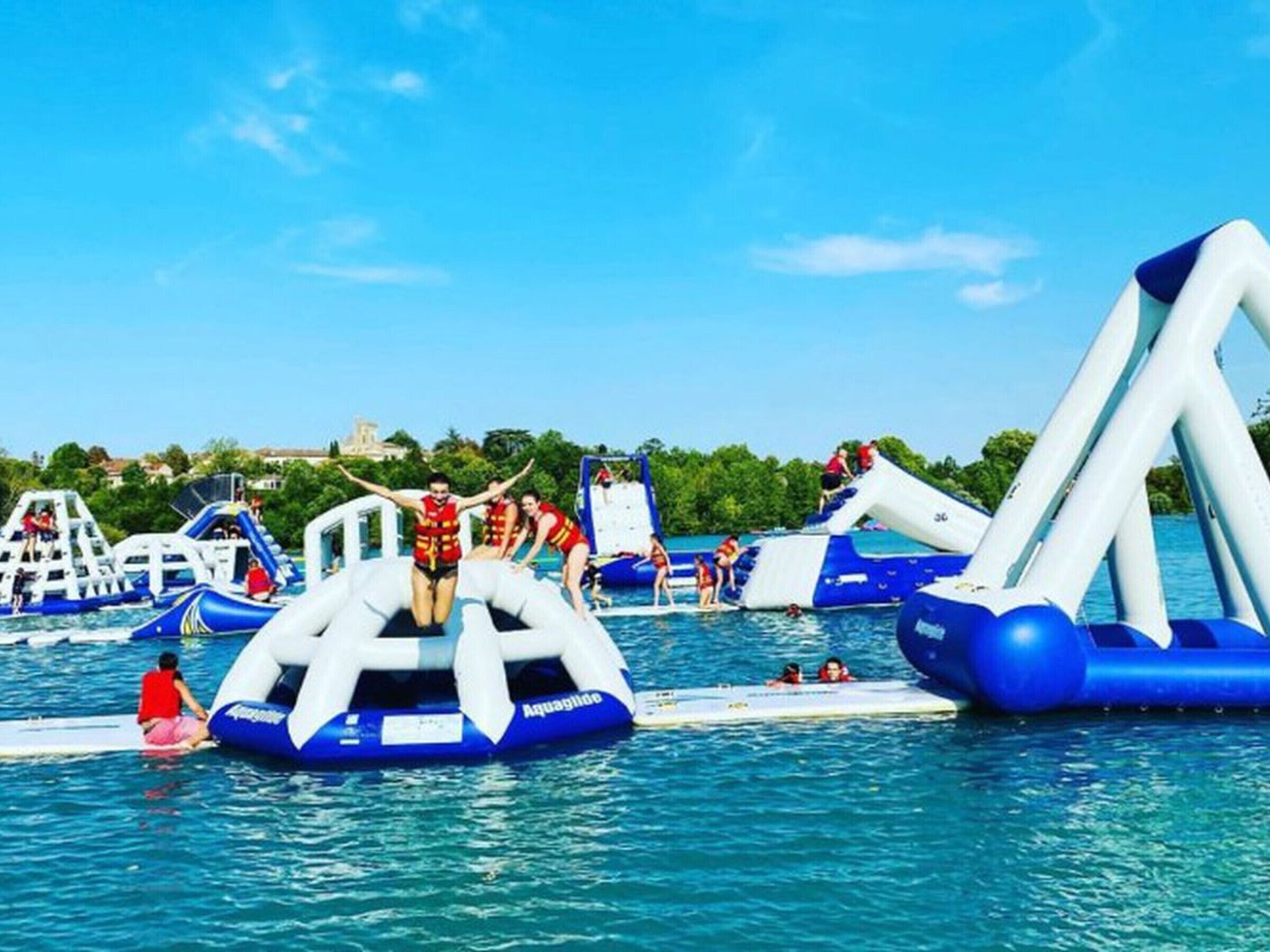 An inflatable water park with various water slides and play structures.