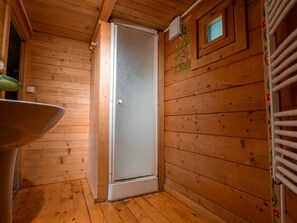 A wooden cabin interior with a door, a small window, and a radiator. - Spacious 54m² Chalet for 6 at Domaine de Dienné (Dienné)