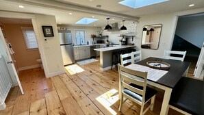 A modern kitchen with a central island, wooden flooring, and skylights. - Downtown Newport Townhouse 2 Br/1.5 Bath/parking 2 Bedroom Apts (Newport)