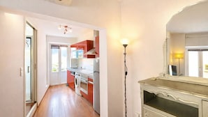 A modern kitchen with red cabinets, a built-in oven, and a washing machine. - Studio 1 Room Center Ajaccio - Air Conditioning, Sleeps 4 (Ajaccio)