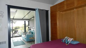 A bedroom with a bed, a wooden wardrobe, and a sliding glass door leading to a balcony. - 2-room apartment with terrace and parking in Le Lavandou (Le Lavandou)