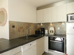 A compact kitchen with a dishwasher, a coffee maker, a toaster, and a microwave. - 2 Bedroom Apartment, Air Conditioning, Parking, Sleeps 4 (Bormes-les-Mimosas)