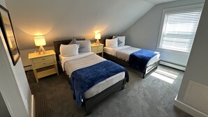 A bedroom with two beds, a window with blinds, a ceiling vent, and bedside lamps. - Unique 2 Bed 1 Bath Apartment Off Broadway #3 2 Bedroom Apts (Newport)