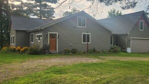 A two-story house with a front porch, a garage, and a well-maintained lawn. - Sunsets on Beaver Dam Lake (Cumberland)