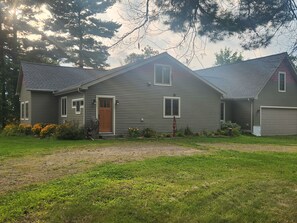 A two-story house with a front porch, a garage, and a well-maintained lawn. - Sunsets on Beaver Dam Lake (Cumberland)