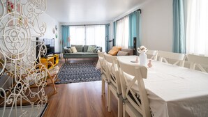 A modern living room with a sofa, dining table, and decorative metal railings. - Unique 4-Level Home in the Heart of Beşiktaş (Istanbul)