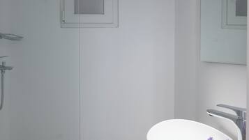 Shower, hair dryer, towels, toilet paper