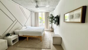 A bedroom with a bed, bedside tables, a potted plant, a ceiling fan, and a window with curtains. - Paradise apartment 2 bedroom / 2 Baths with parking in vibrant Miami (Miami)