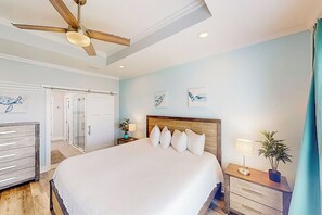 A bedroom with a large bed, a ceiling fan, a nightstand with a lamp, and artwork on the wall. - 🏖️Pet Friendly - Short Walk to Beach - Great Location - Turtle Beach Retreat🏖️ (Panama City Beach)