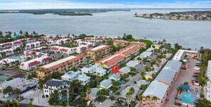A coastal resort with multiple buildings, a marina, and a large body of water. - Perfect Beach Escape - Charming 1 Bedroom Condo Just Steps From The Sand (Bradenton Beach)