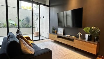 Deluxe Apartment, City View | Living area | Flat-screen TV