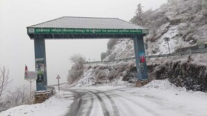 A snow-covered road with a signpost and a bridge. - Kabila King Resort (Chakrata)