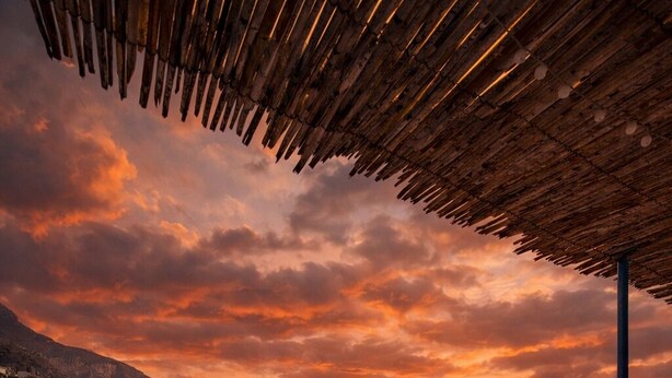 A coastal town with a view of the sea and mountains during sunset. - Casa Lucia  (Positano)