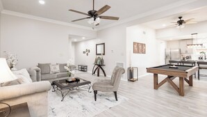 A spacious living room with a sofa, coffee table, and a pool table. - Gig ‘Em Ags! Pool table, patio, 7 mins Kyle Field (Bryan)