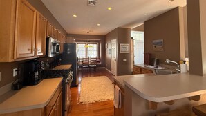 A modern kitchen with wooden cabinets, a stainless steel refrigerator, and a built-in stove. - Tremendous 5-bedroom house in Pocono Pines (Pocono Pines)