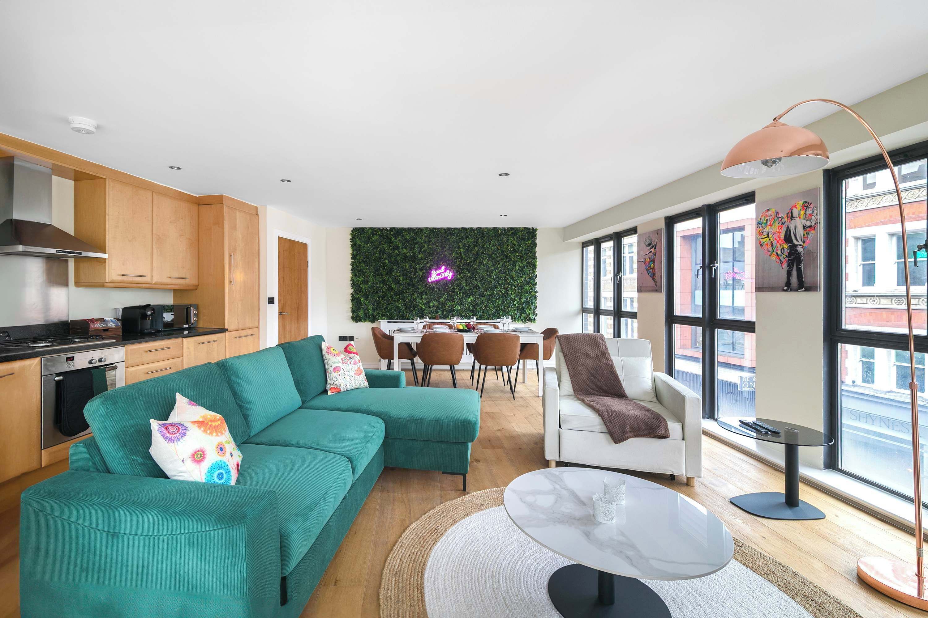 A modern apartment with a kitchen, dining area, and living room.
