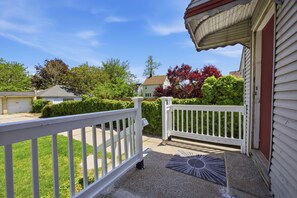 A residential property with a white porch, a gated entrance, and a clear sky. - Bright Tremont 2BR - Near Downtown CLE & Clinic (Cleveland)