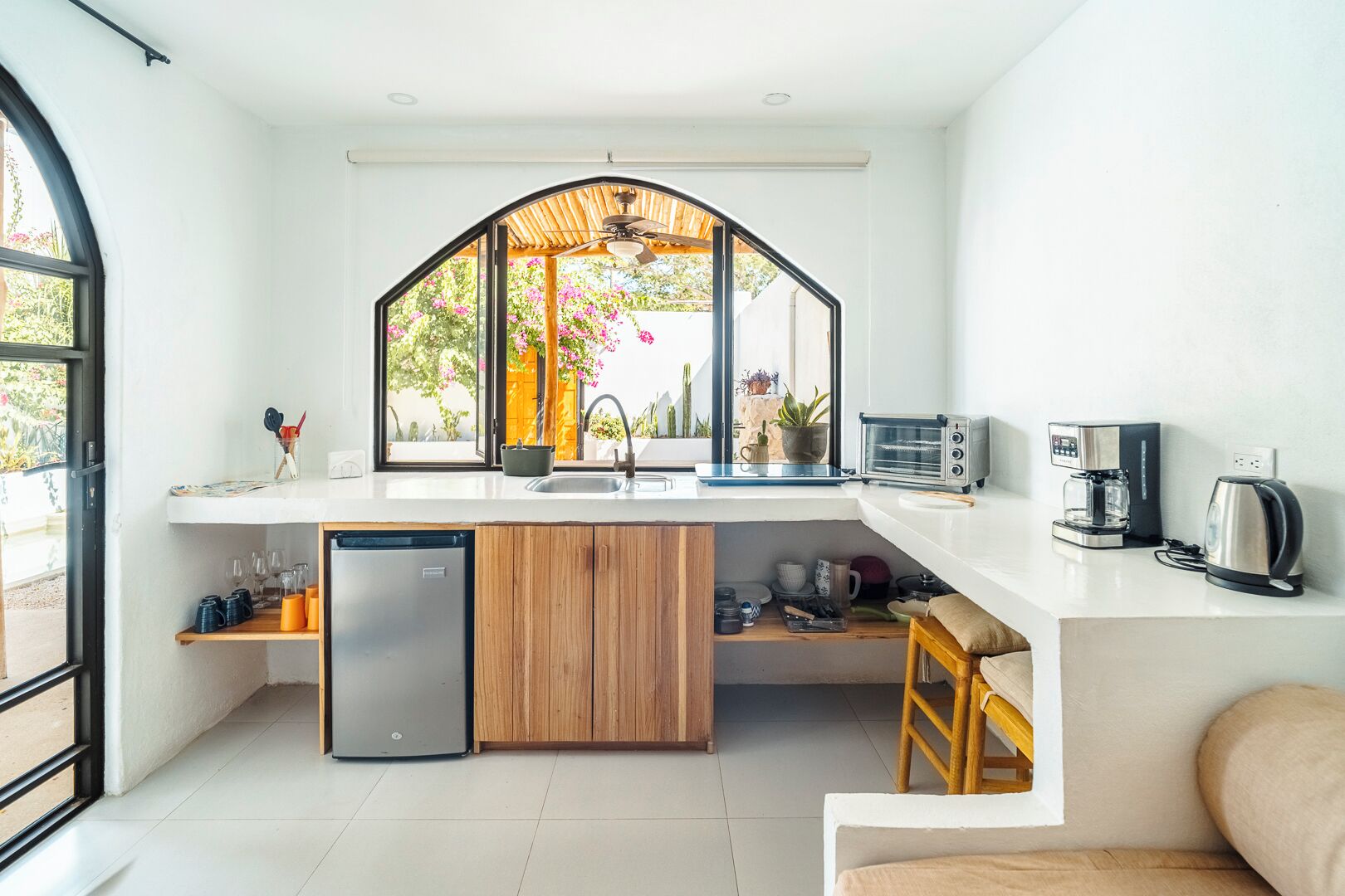 A modern kitchen with a built-in dishwasher, a coffee machine, and a toaster.