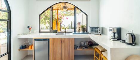A modern kitchen with a built-in dishwasher, a coffee machine, and a toaster.