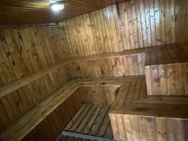 A wooden interior with a sloped ceiling and a central staircase. - Hosteria Agoyan Spa (Ulba)