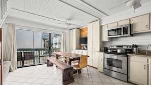 Een moderne keuken met een houten tafel en stoelen, een ruime oven en een magnetron.