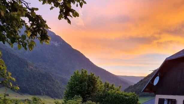 A picnic setup on a grassy area with a scenic mountain view in the background. - GITE DES FONTANETTES (LA COMPOTE)