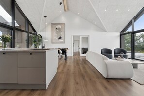 A modern interior with a kitchen, dining area, and living space.