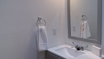 Combined shower/bathtub, towels, soap, shampoo