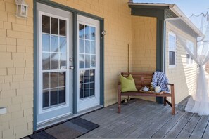 A porch with a bench, a door, and a lantern. - Spyglass Seastead in Chester Basin (Western Shore)