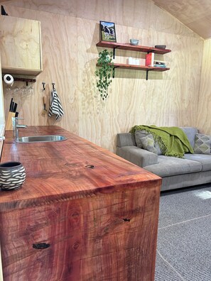 Living area - Secluded Redwood Cabin.  Built from a redwood tree that blew down in a cyclone (Ashley Clinton)