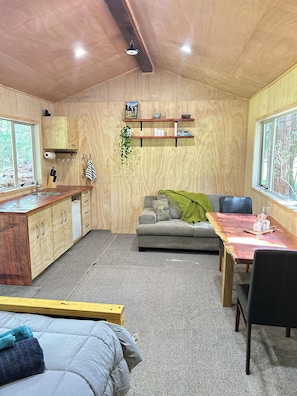 Living area - Secluded Redwood Cabin.  Built from a redwood tree that blew down in a cyclone (Ashley Clinton)