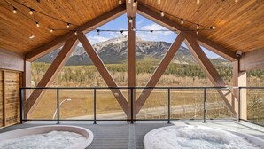A hot tub area with a wooden ceiling and a view of mountains. - 4BR Getaway with MTN View, Balcony Near DT & Banff! (Canmore)