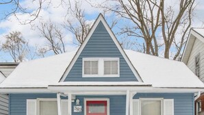 A two-story house with a red door, white shutters, and a number 382 sign. - Cozy Home Near Ferndale, Royal Oak & Detroit! (Hazel Park)