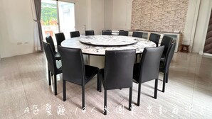 A conference room with a round table and black chairs, a stone wall, and a ceiling with recessed lighting. - dream castle (Wujie)