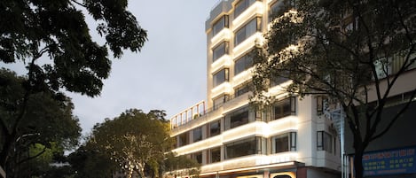 A multi-story hotel with a modern design, featuring balconies and large windows.
