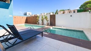 A rooftop pool area with lounge chairs, a wooden deck, and a view of the cityscape. - Apartment located near the beach and the shopping mall. (MACEIÓ)