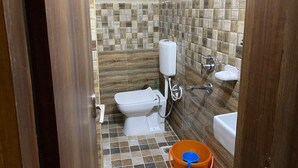 A small bathroom with a toilet, sink, and bathtub. - New Hotel Tuk Tuk Palace (Ranchi)