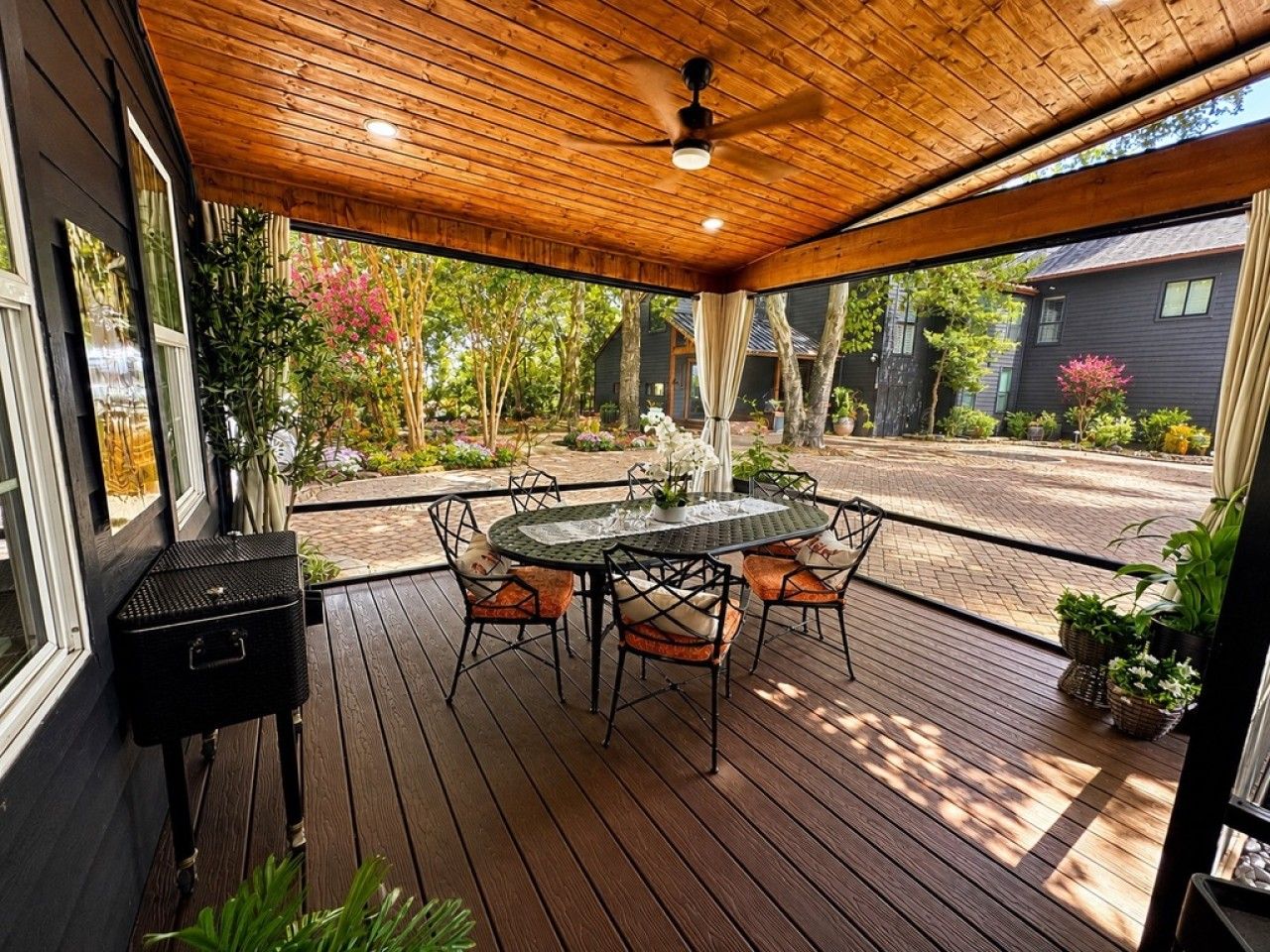 Covered, screened dining at The Luxe Cottage on the Oak Canopy Porch