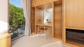 A modern bedroom with a wooden wardrobe, a desk with a chair, and a large window with a view of trees. - LuxPride Villas Private Pool Tropiclook (Si Sunthon)