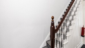 A staircase with a wooden handrail and white balusters. - Standard Double Room (Salford)