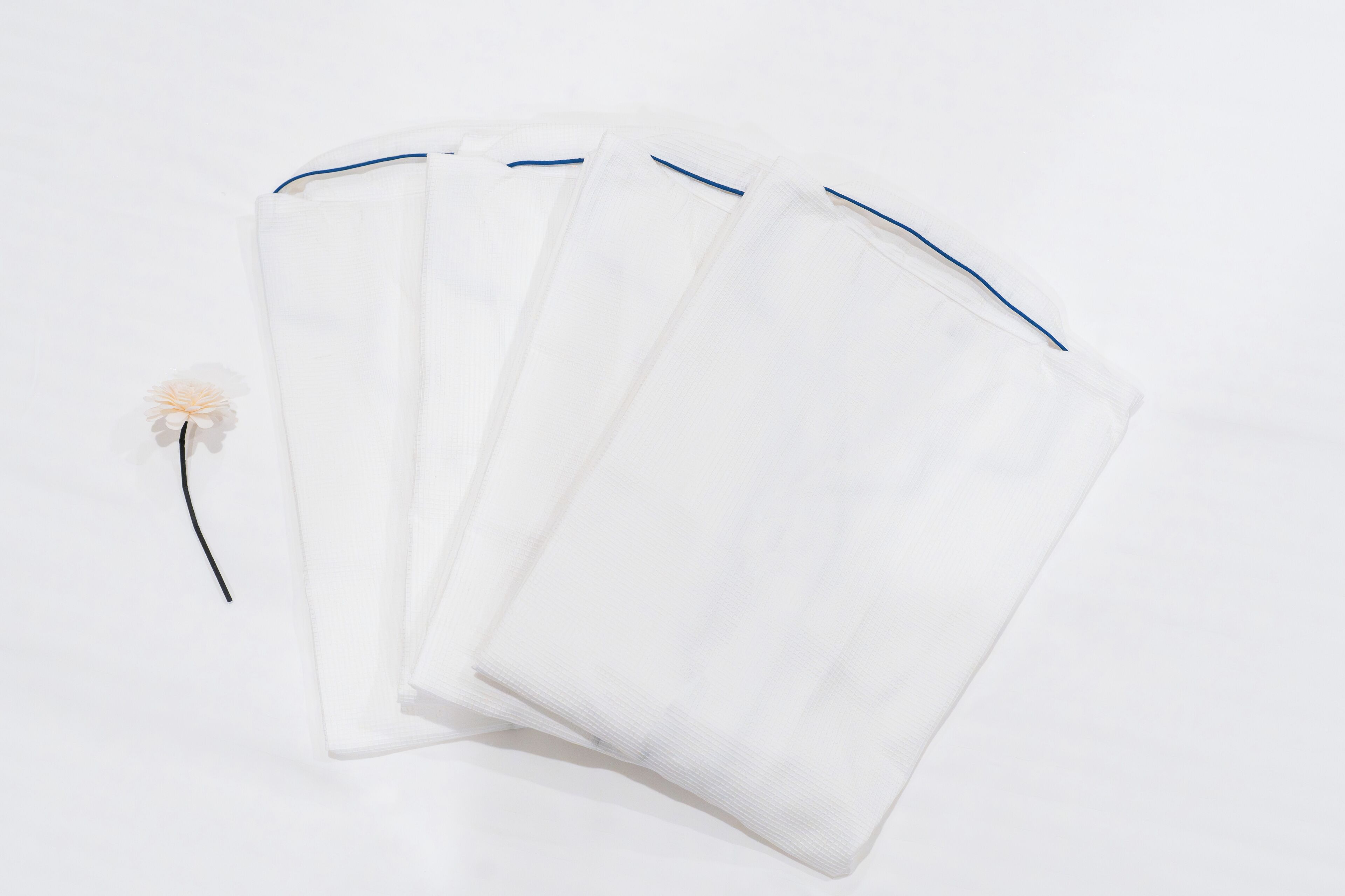 A white fan with a blue trim and a single feather.