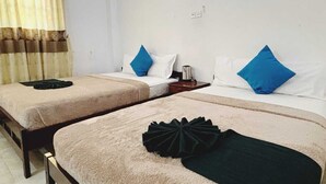 A hotel room with two single beds, each with a pillow and a bedside table. - Blue Mountain Resort Bandarawela  (Bandarawela)