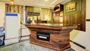 A reception desk labeled 'Townhouse' with a sign indicating it is company-serviced. - Classic Hotel sai Leela Residency (Ramagundam)