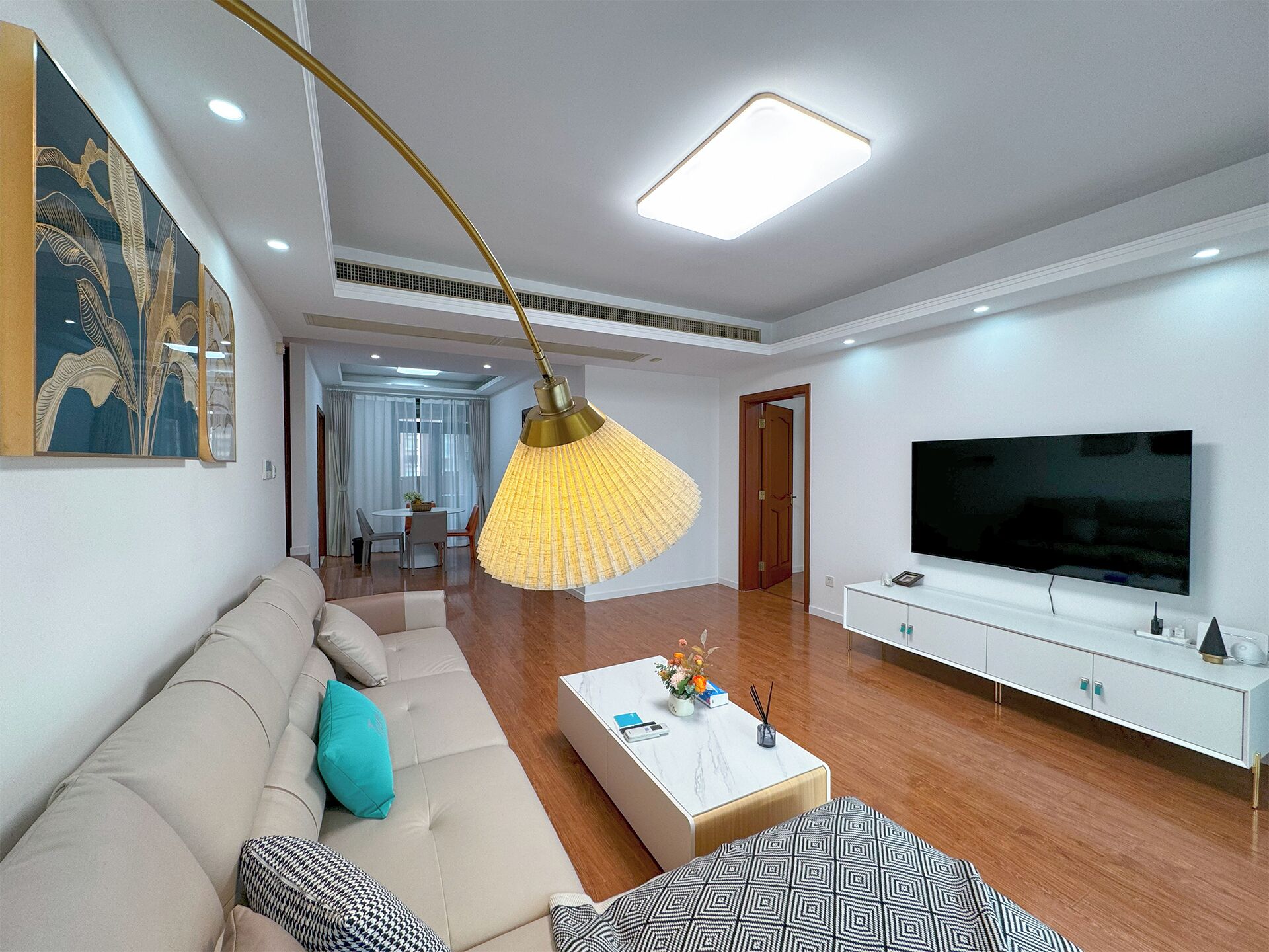 Una sala de estar moderna con un sofá, una mesa de centro y una televisión.