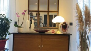 A bathroom vanity with a mirror, a bowl, a lamp, and decorative plants. - LA TOUR DE SAINT XANDRE LA ROCHELLE (Saint-Xandre)