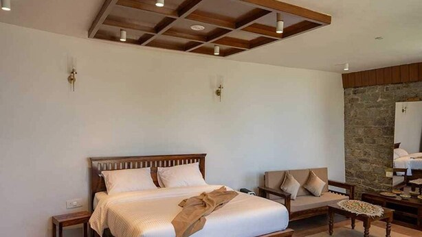A bedroom with a wooden bed, a bench, and a stone wall. - Palette Orient Greenz Pench by Checkin (Kurai)