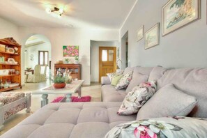 A living room with a sofa, a wooden cabinet, and a coffee table. - Villa with private pool (Tar/Poreč)
